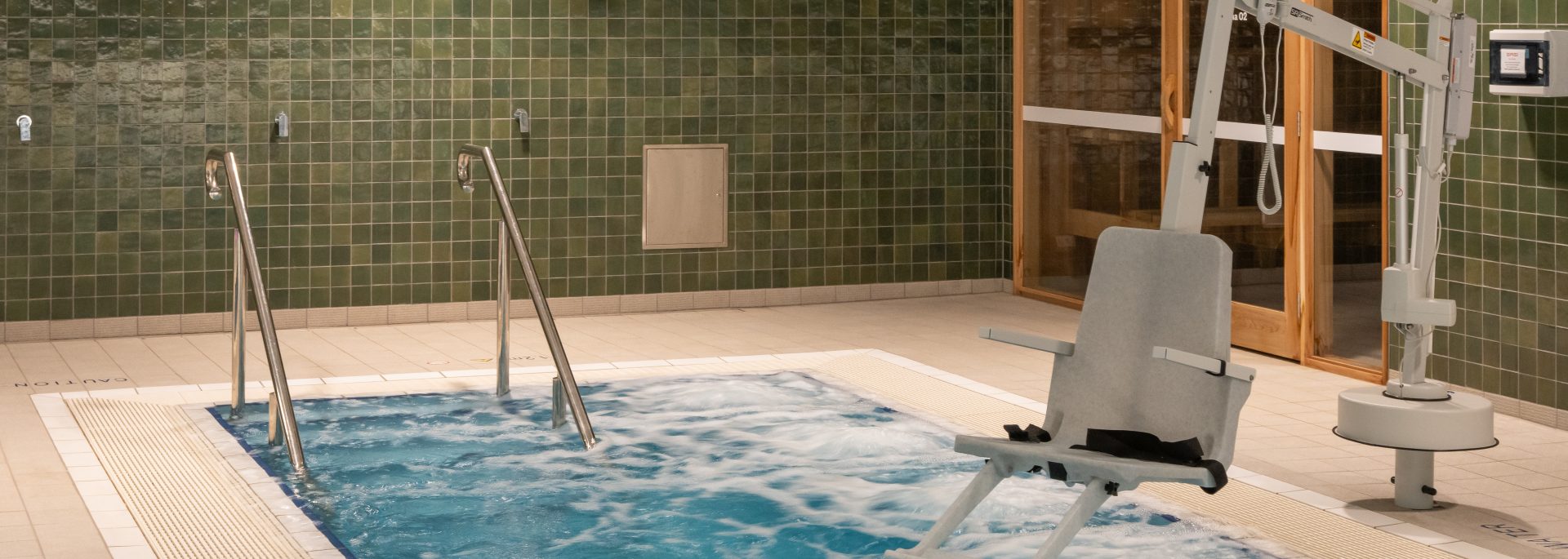 Corner view of SASI's recovery pool with accessibility chair